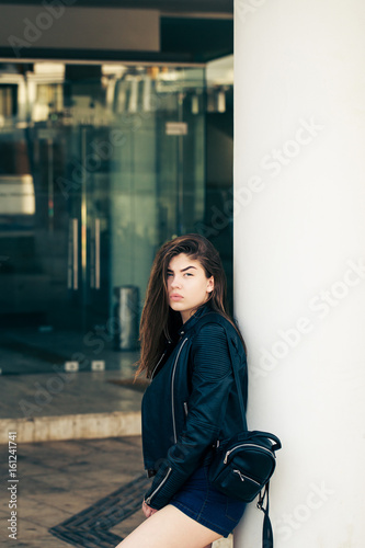 Pretty teenage girl posing on the street