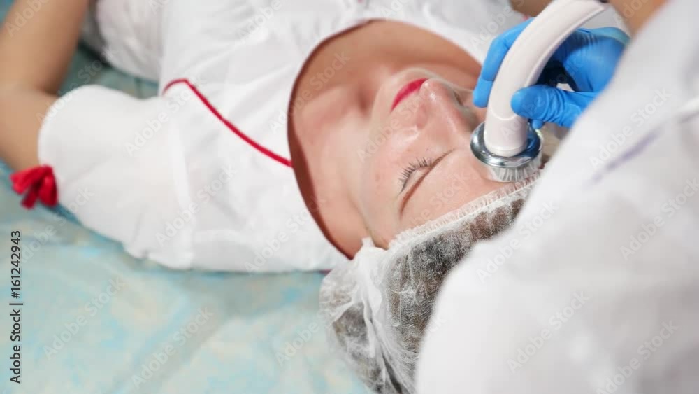 The girl doing cosmetic procedures in spa clinic The girl doing cosmetic procedures in spa clinic