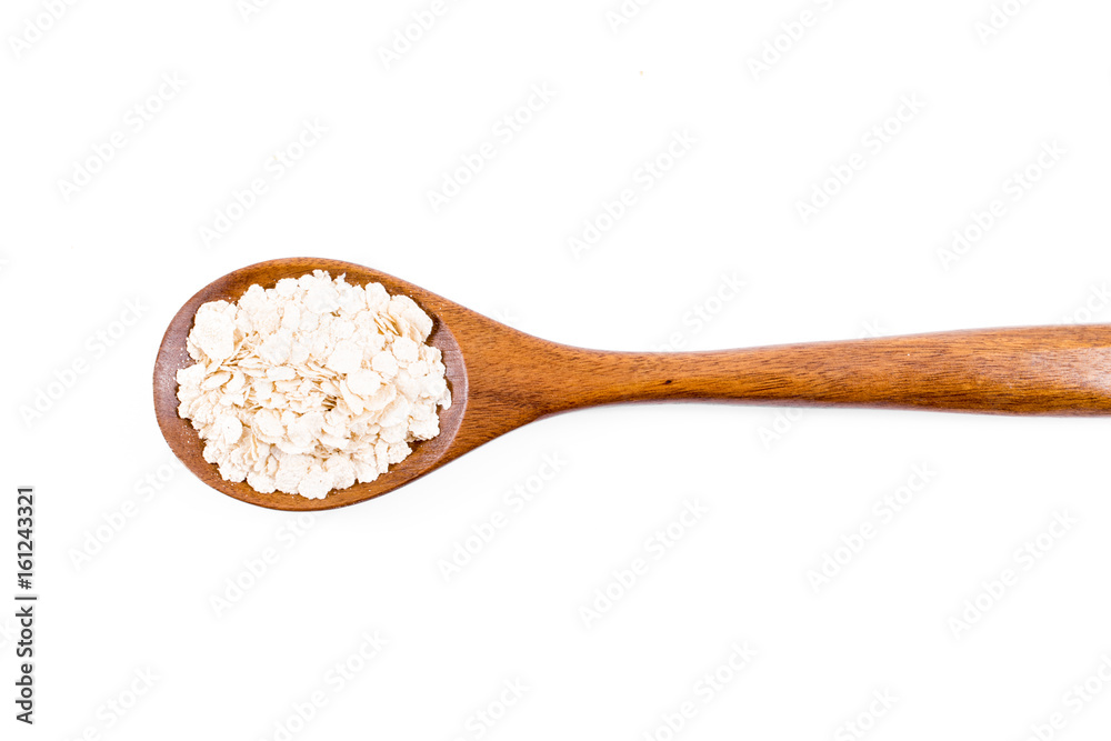 oat flakes in wooden spoon isolated on white background oat flakes in wooden spoon isolated on white background