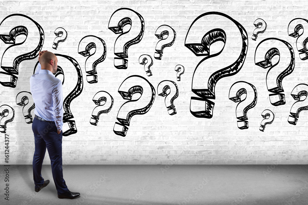 View of a Businessman in front of a wall trying to find find answers - Daily life concept View of a Businessman in front of a wall trying to find find answers - Daily life concept