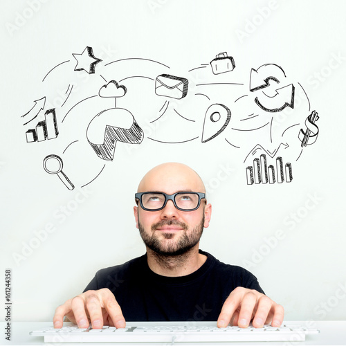 Portrait view of an attractive dubious geek with business icons surrounding his head - Business concept