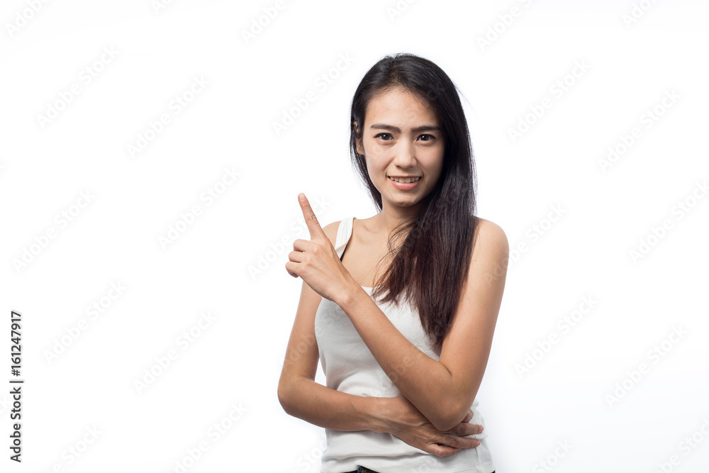 Asian young woman pointing at space on white background Asian young woman pointing at space on white background