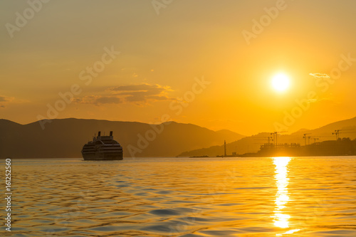 A large liner sails in the rays of the sunset along the Boka-Kotorska Bay. Montenegro. © Sergej Ljashenko