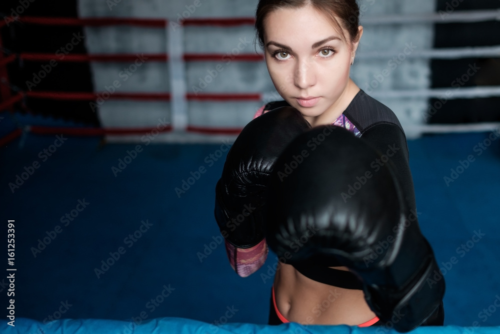 Young adult sexy boxing girl posing with gloves.