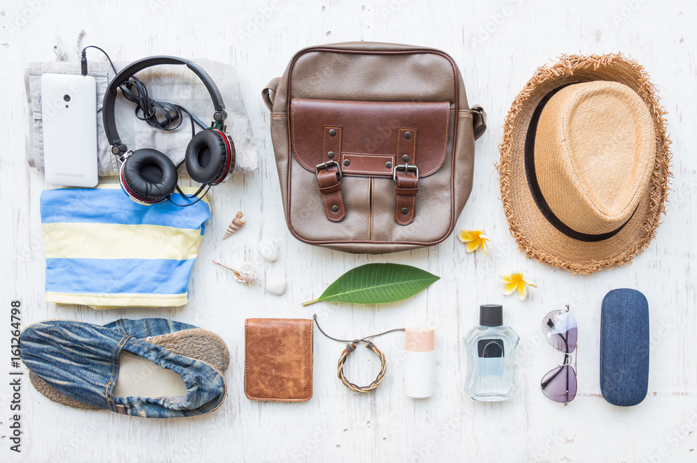 Men's casual summer clothes with accessories items on white rustic wooden board background, overhead top view, flay lay Men's casual summer clothes with accessories items on white rustic wooden board background, overhead top view, flay lay
