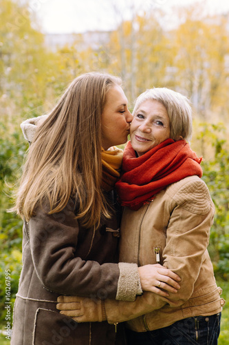  Happy mother and daughter portrait. Portrait of beautiful mature mother and her daughter .