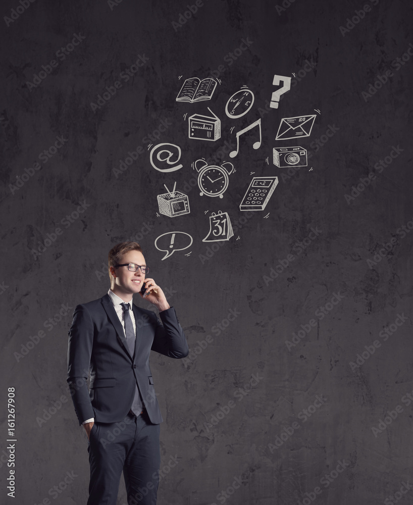 Businessman checking his smartphone on a dark dramatic background. Business, office, idea concept. Businessman checking his smartphone on a dark dramatic background. Business, office, idea concept.
