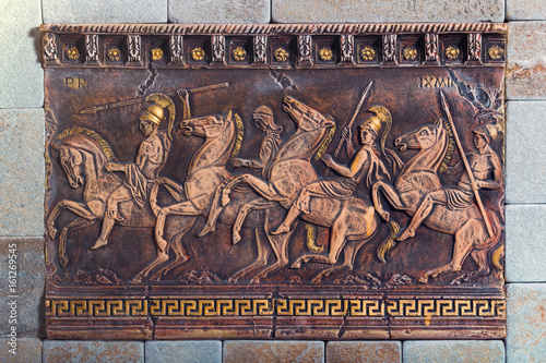 Photography Bas relief of the ancient soldiers on the battle horses