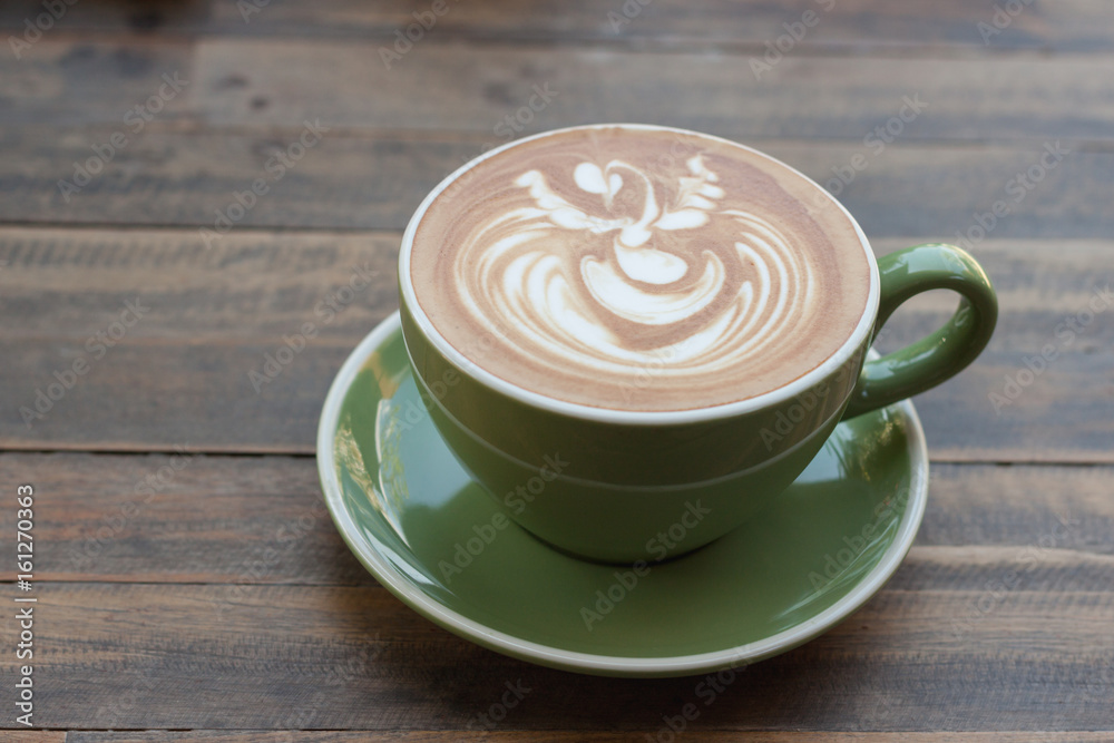 Cup of hot coffee latte with beautiful style on wood table Cup of hot coffee latte with beautiful style on wood table
