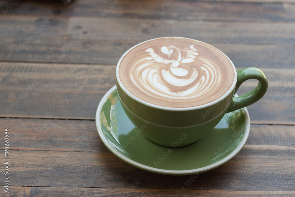 Cup of hot coffee latte with beautiful style on wood table Cup of hot coffee latte with beautiful style on wood table