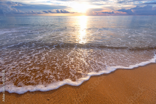 Fototapeta Naklejka Na Ścianę i Meble -  Soft wave of blue ocean on sandy beach. Background.