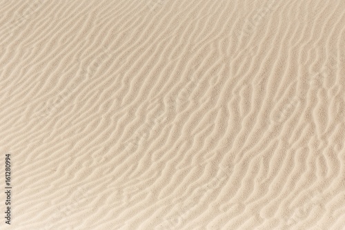 Sandy waves, sand on the beach or desert texture pattern