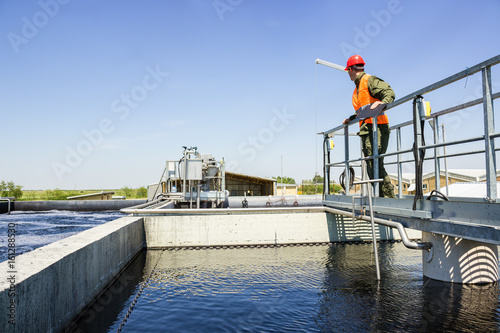 Man monitor filtering water in factory