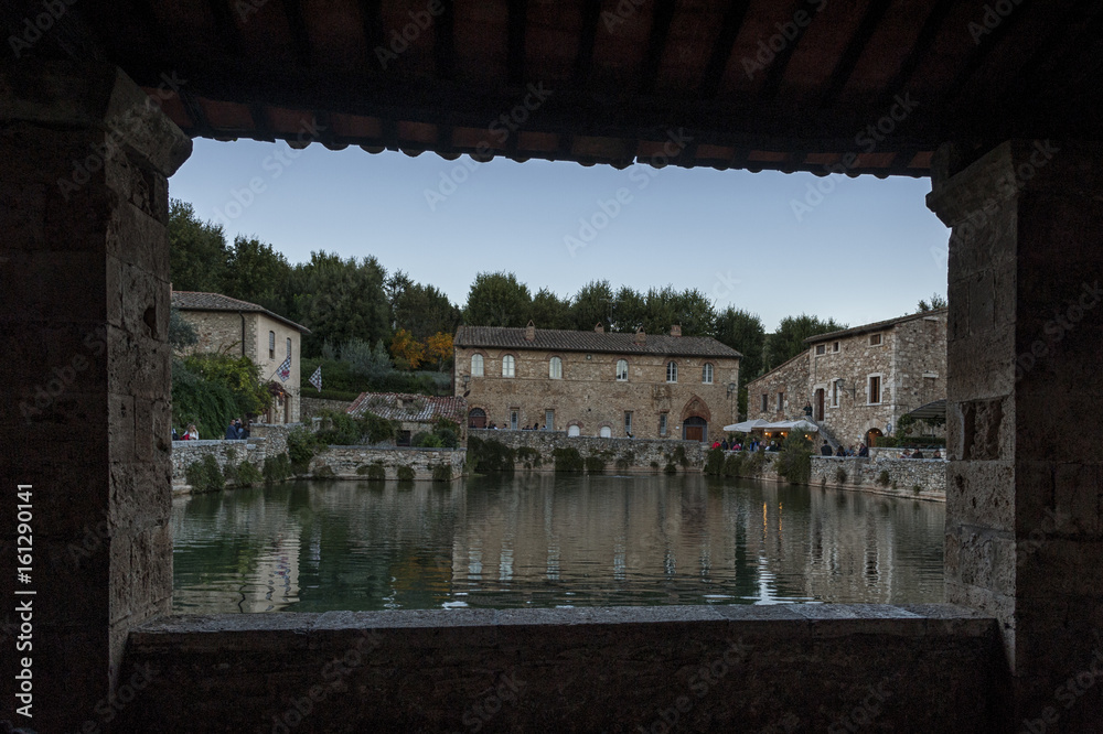 BAGNO VIGNONI, TUSCANY ITALY - October 30, 2016: Undefined people in the old  thermal baths in the medieval village Bagno Vignoni, Tuscany, Italy - Spa basin in the antique italian town.