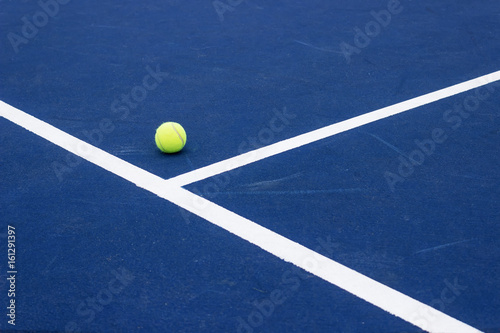 Tennis ball on tennis court. Blue hard surface. © Ivan