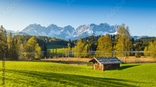 Idyllic alpine scenery, cabin in front of snowy mountains, Kitzbühel, Tyrol, Austria photo