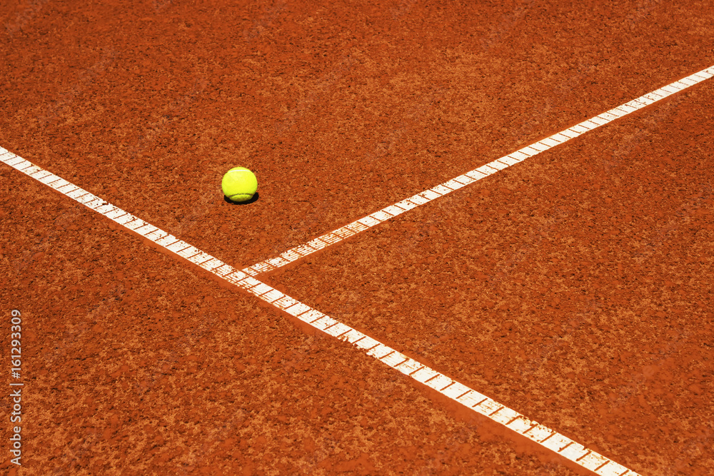 Tennis ball on tennis court. Clay surface.
