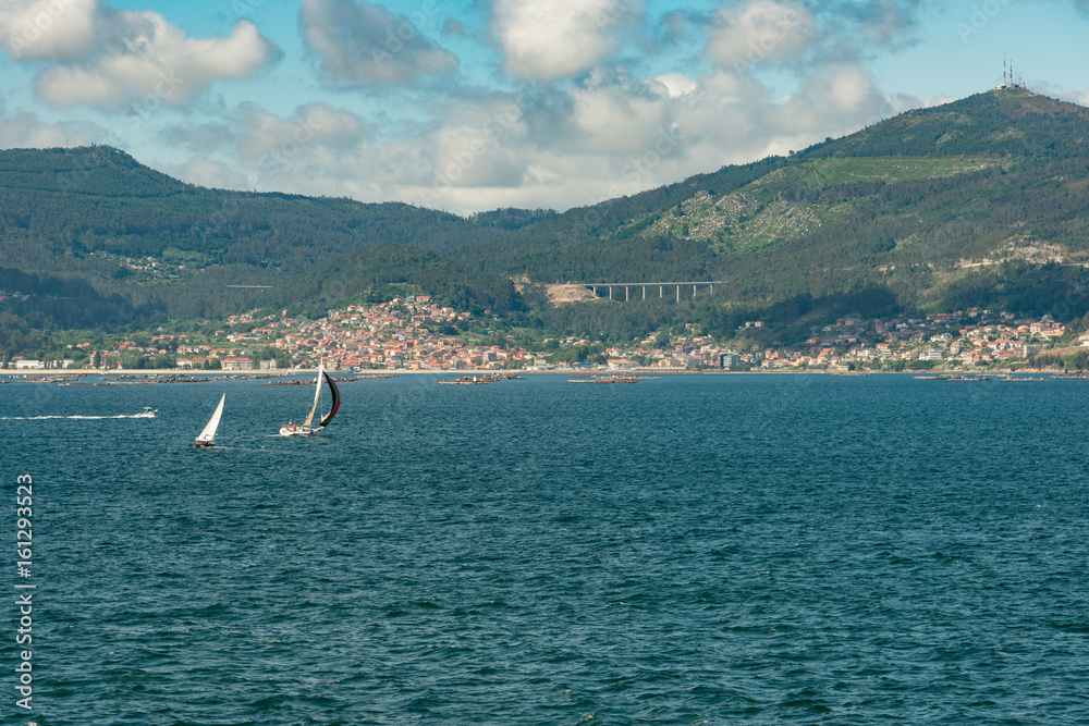 Obraz premium View from the sea of Vigo, Spain with mussel farms, sailboats and copy space 