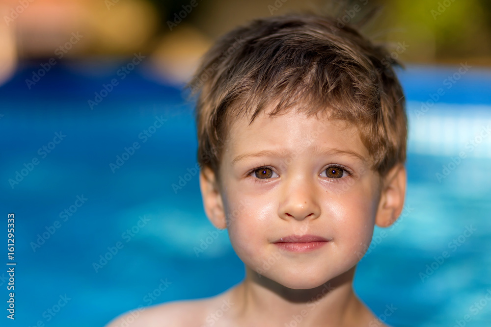 young boy playing in swimming pool wirh float ring young boy playing in swimming pool wirh float ring