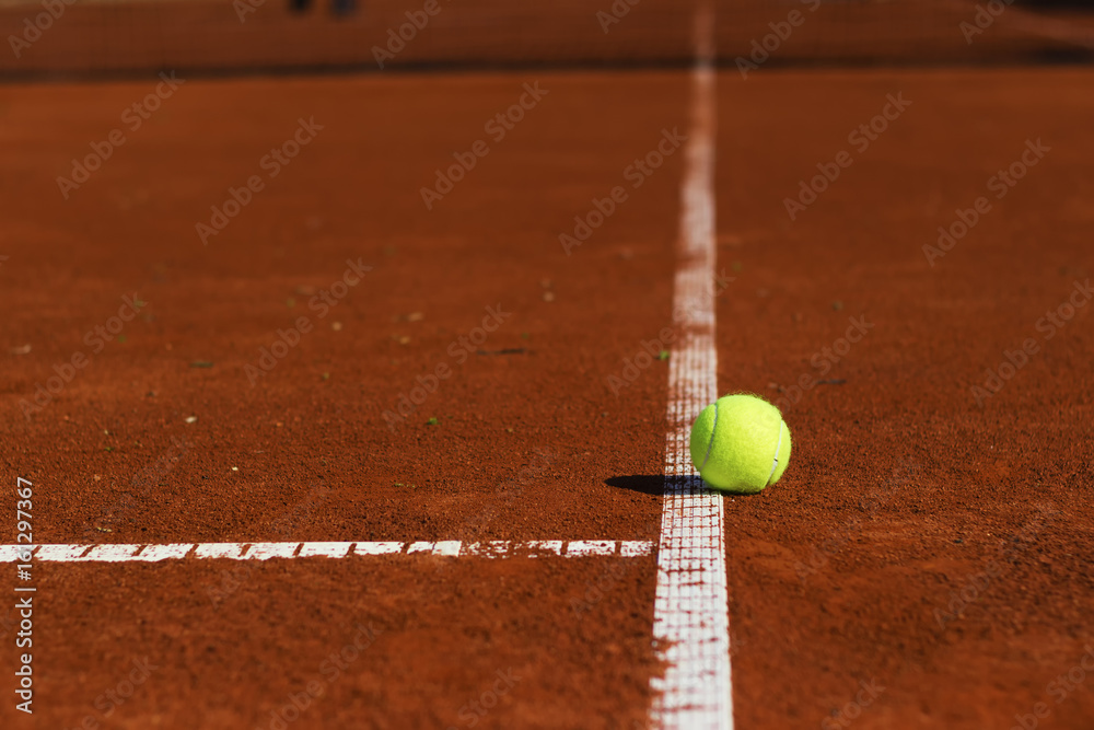 Tennis ball on tennis court. Clay surface