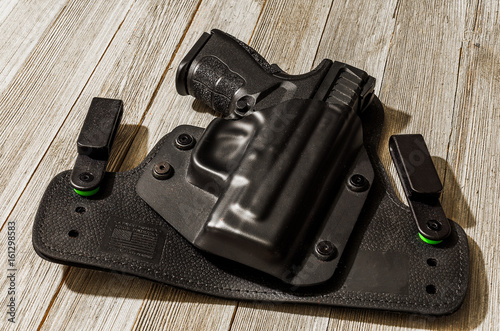 Black handgun on wood table