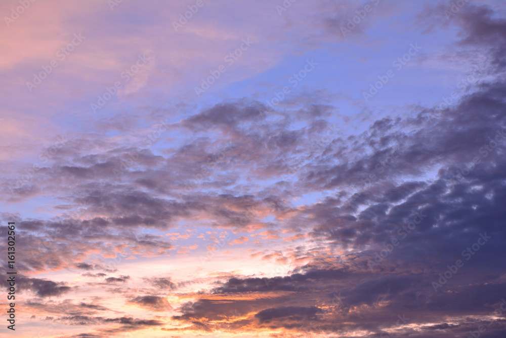 Colorful clouds on blue sky background with sunrise.