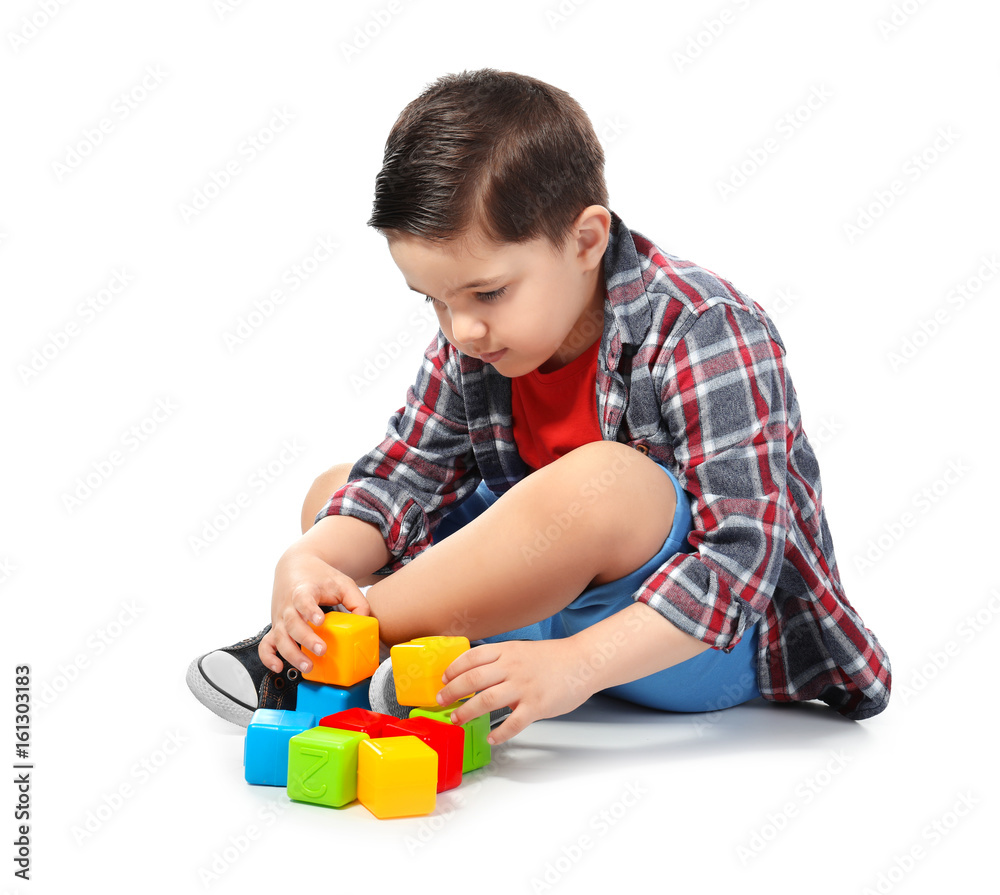 Cute little boy playing with colorful cubes on white background Cute little boy playing with colorful cubes on white background