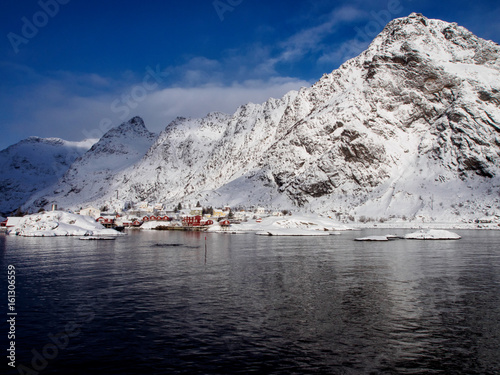 Small fishermen's village of A on Lofoten, Norway under snow-capped peaks