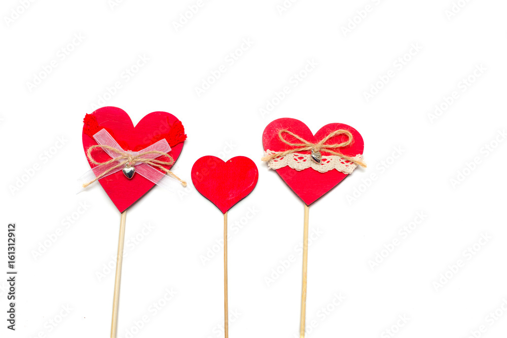 Two hearts on a wooden stick on a white background.