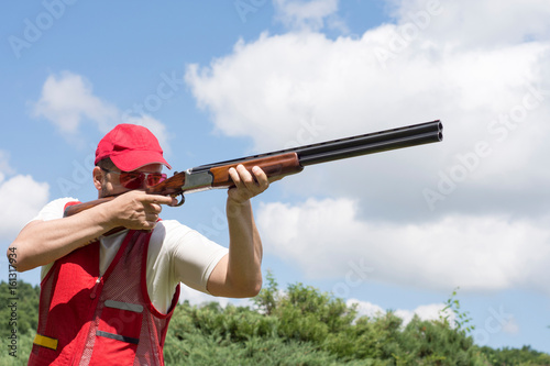 Man shooting skeet with a shotgun photo