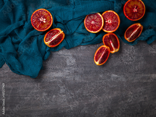 Blood Orange a knife on a dark Background.Vintage style.Food or Healthy diet concept.Vegetarian.Copy space for Text. selective focus.