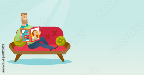 Man reading a magazine on the couch.