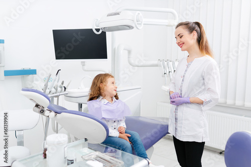 Dentist and small girl in cabinet