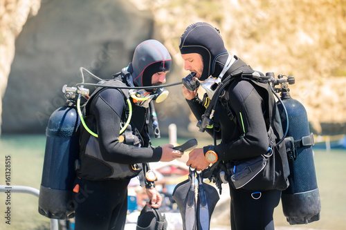 Scuba divers checking their equipment