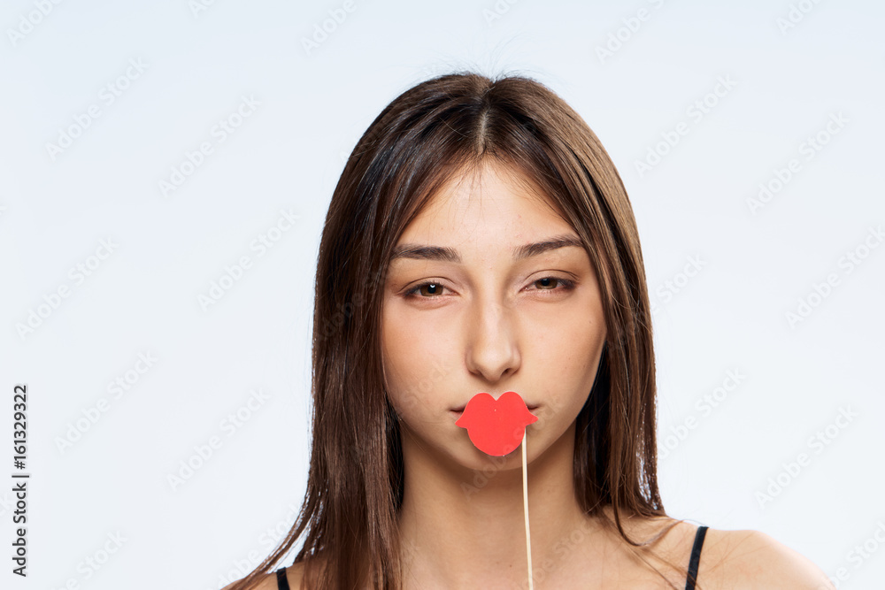 Woman with lips on stick, holiday, woman on light background Woman with lips on stick, holiday, woman on light background