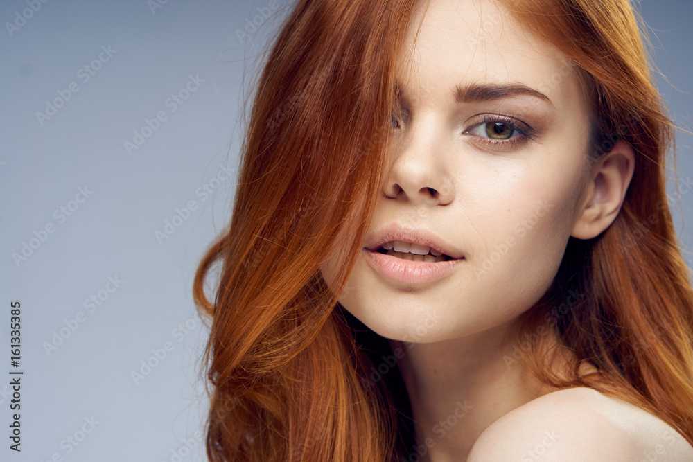 Young woman, beautiful woman, hair care, healthy hair, woman on gray background portrait Young woman, beautiful woman, hair care, healthy hair, woman on gray background portrait