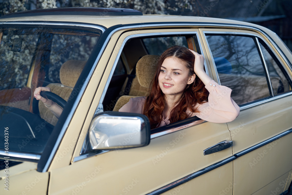 Woman driving a car, a woman peeking out of a car window