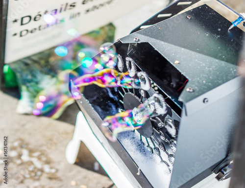 Soap bubble machine with colorful bubbles macro closeup