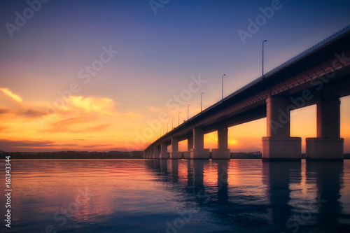 Bridge over the river at sunset © Konstantin