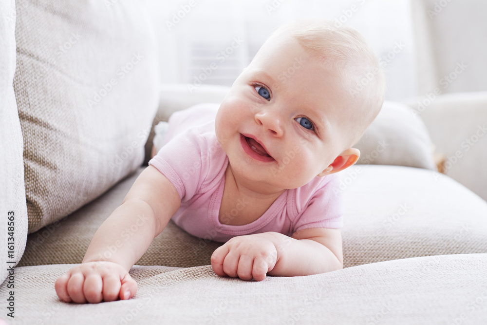 Wonderful small girl crawling on sofa Wonderful small girl crawling on sofa