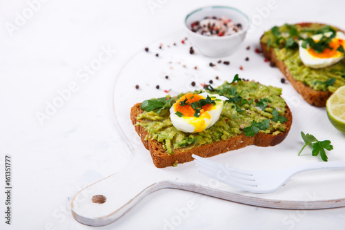 Avocado Vegetable. Sandwiches with Guacamole ,Egg and Parsley on a White Background.Appetizer.Food or Healthy diet concept.Copy space for Text. selective focus.