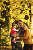 Family walking in autumn park