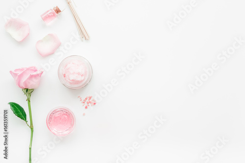 homemade spa with rose cosmetic set, cream, salt and oil on white background top view mock-up