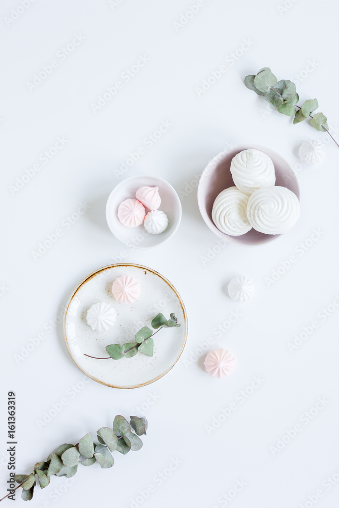 sweet lunch with marsh-mallow and spring flowers for woman on white background top view sweet lunch with marsh-mallow and spring flowers for woman on white background top view