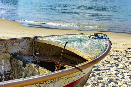 Old fishing boat on the sand of Copacabana beach in Rio de Janeiro photo