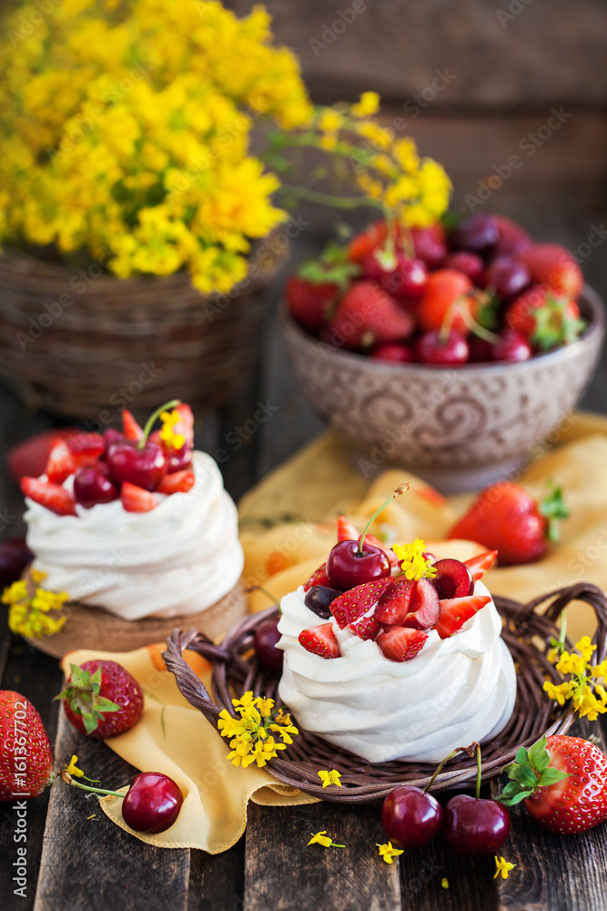 Delicious mini Pavlova meringue cake decorated with fresh berries