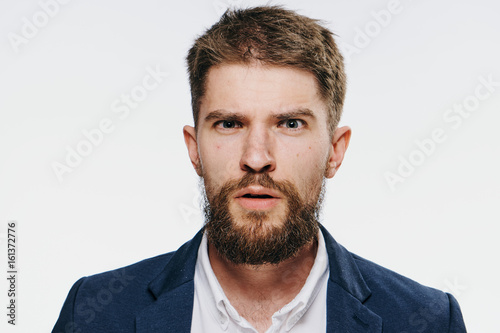 Businessman, surprised businessman, businessman with beard on light background portrait