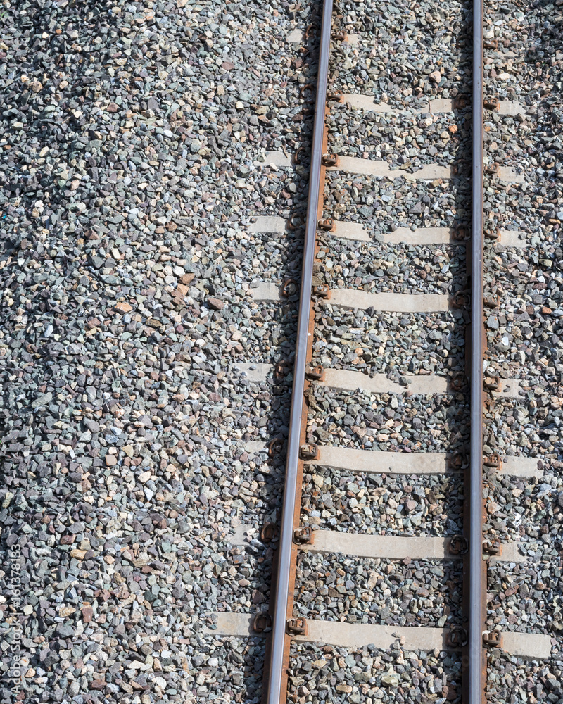 Close to the railroad with rocks.