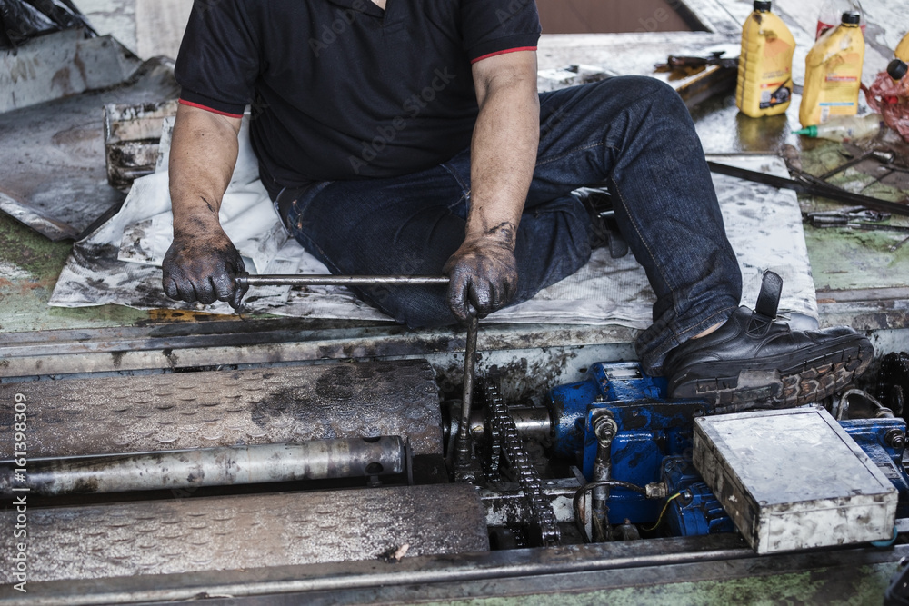 repairman holding a wrench and tighten and during maintenance work of machine repairman holding a wrench and tighten and during maintenance work of machine