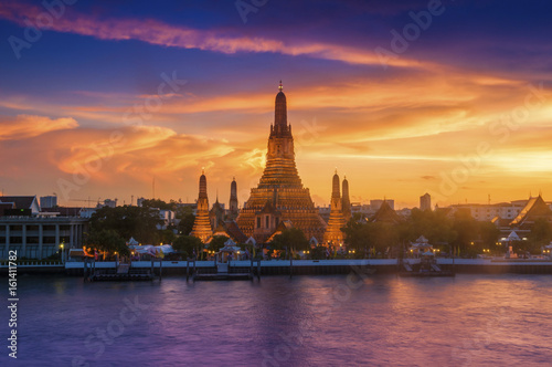 Wat Arun Ratchawararam is a beautiful temple, the great pagoda in the evening at the magnificent light and beautiful golden sky, Bangkok Thailand.